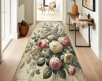 May include: A rectangular floral runner rug featuring a bouquet of pink, white, and purple roses and other flowers. The rug has a distressed, vintage look with a light beige background and a brick-like pattern.