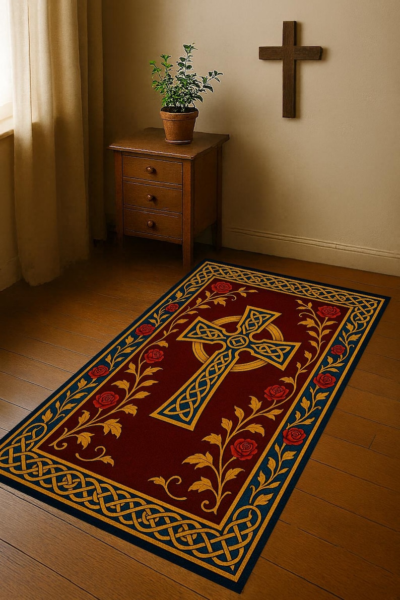 May include: A rectangular rug with a burgundy field features a gold Celtic cross design. The border is navy blue with gold Celtic knotwork and red roses. A wooden cross hangs on the wall above the rug.