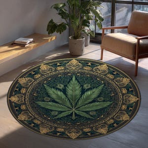 May include: A round rug with a dark teal background and a large green cannabis leaf in the center. The leaf is surrounded by an ornate gold border with leaf-like designs. The rug is placed on a light-colored wooden floor.