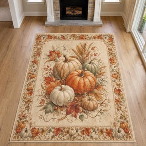 May include: A rectangular area rug featuring a central illustration of various pumpkins in shades of orange, white, and green, surrounded by autumn leaves and wheat stalks. The border displays a repeating pattern of small pumpkins and fall foliage.