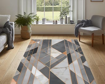 May include: Geometric patterned area rug in shades of gray, white, and black with copper-colored accents. The rug features a modern design with angular shapes and lines, suitable for a living room or bedroom. The rug's dimensions are approximately 60 inches by 90 inches.