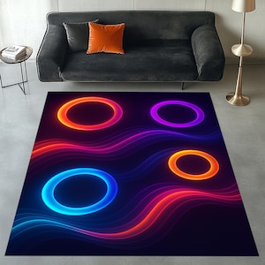 May include: A rectangular area rug with a dark background features four glowing, colorful circles in orange, purple, blue, and orange. Wavy lines in shades of red, orange, and blue flow across the rug, creating a vibrant, modern design.
