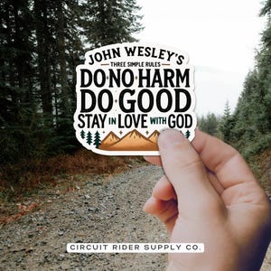 May include: A white sticker with black text that reads "John Wesley's Three Simple Rules: Do No Harm, Do Good, Stay in Love with God." The sticker also features a mountain graphic and the text "Circuit Rider Supply Co."