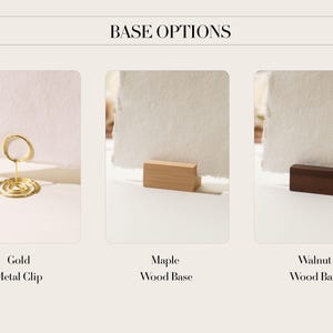 May include: Image showcasing three base options: a gold metal clip, a maple wood base, and a walnut wood base. Each base supports a piece of textured white paper. The text "BASE OPTIONS" is at the top of the image.