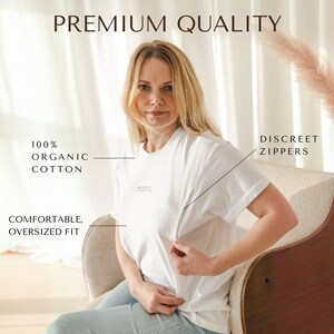 May include: A white t-shirt with a discreet zipper, made from 100% organic cotton. The t-shirt has an oversized fit and the word "mama" is printed on the front.