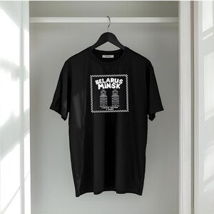 May include: Black t-shirt with a white graphic featuring the text "BELARUS MINSK" inside a checkered square, along with an illustration of two buildings. The words "LIMITED EDITION" are below the buildings.