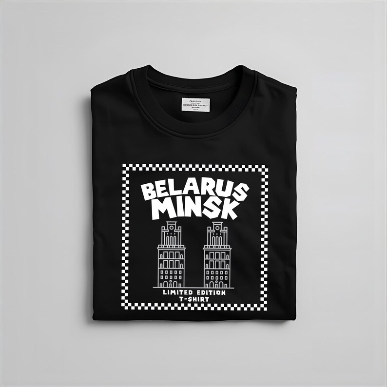 May include: Black crew neck t-shirt with a white graphic that reads "BELARUS MINSK" above a line drawing of two buildings. The graphic is framed with a checkered border and the text "LIMITED EDITION T-SHIRT" is below the buildings.