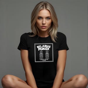May include: Black t-shirt featuring a white graphic of two buildings and the text "BELARUS MINSK" inside a checkered border. The words "LIMITED EDITION T-SHIRT" are below the buildings.