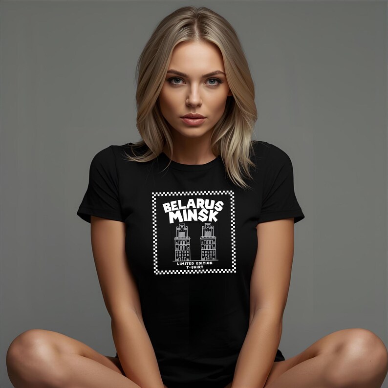 May include: Black t-shirt featuring a white graphic of two buildings and the text "BELARUS MINSK" inside a checkered border. The words "LIMITED EDITION T-SHIRT" are below the buildings.