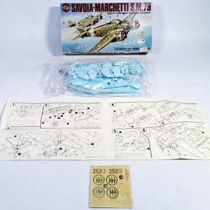 May include: A model kit of the Savoia-Marchetti S.M.79, an Italian trimotor torpedo bomber. The box art shows the plane in flight. The kit includes plastic parts, instructions, and decals. The box reads "SAVOIA-MARCHETTI S.M.79 ITALY'S TRIMOLOR TORPEDO BOMBER 1/72 MODEL KIT".