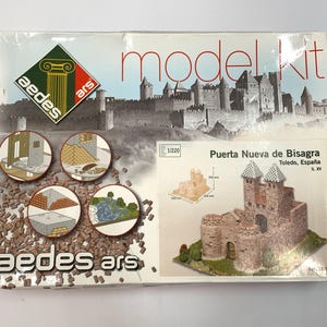 May include: A model kit box showing the "Puerta Nueva de Bisagra" from Toledo, Spain. The box includes a model of the castle, diagrams, and the "aedes ars" logo. The kit is 1/220 scale.