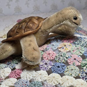 May include: A set of three ceramic mugs with a speckled, matte finish. Each mug features a different color: light blue, cream, and gray. The mugs have a simple, modern design and a comfortable handle.