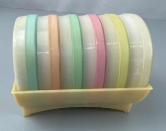 sous-verres vintage MCM en pot, couleurs pastel dans un support de rangement