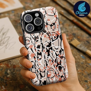 May include: A phone case with a unique abstract design. The case features a pattern of black, white, and coral-colored shapes on a beige background. The Chroma Shell logo is visible in the upper right corner.
