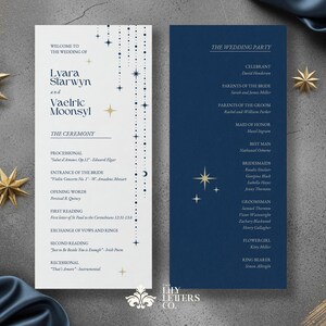 May include: Wedding menu cards with a celestial theme. The cards feature a navy blue and white colour scheme with gold star accents. The left card lists the ceremony details, while the right card lists the wedding party.