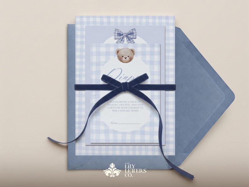 May include: Baby shower invitation set with a blue gingham pattern, a teddy bear graphic, and a navy blue velvet ribbon. The invitation includes the text "Diaper Raffle" and other details.