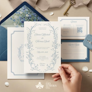 May include: A wedding invitation suite with a blue and white floral design. The invitation features the names Olivia Mitchell and Thomas Scott, the wedding date May 15th, 2020, and the location Villa Sonoma, Sonoma, California. The RSVP card includes a blue border and the text "Kindly Reply by April 15th, 2020". The details card includes a blue border and the text "Details".