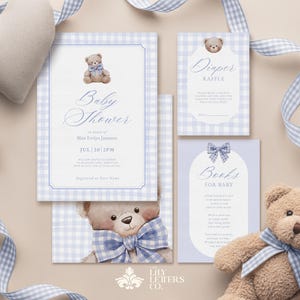 May include: A baby shower invitation set with a teddy bear theme. The invitation, diaper raffle, and book request cards feature a blue and white gingham pattern and teddy bear illustrations. A plush teddy bear and heart-shaped pillow are also present.