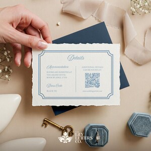 May include: A white card with blue text and a blue border. The card has the word "Details" at the top and includes information about accommodation, dress code, and additional details. A QR code is included for additional details.