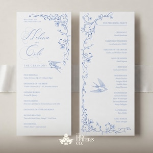 May include: Elegant wedding programs with blue floral and bird illustrations. The programs feature the names "Helena and Cole" and details of the ceremony and wedding party. The Lily Letters Co. logo is at the bottom.