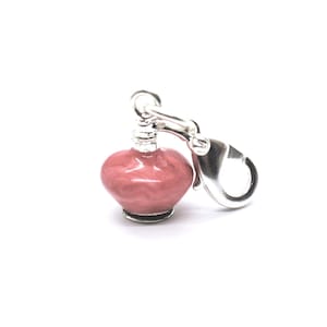 May include: A small, rounded charm featuring a glossy, marbled pink enamel finish on a silver-toned metal base. The charm is attached to a silver-toned lobster claw clasp, designed for easy attachment to bracelets, necklaces, or other jewelry items.