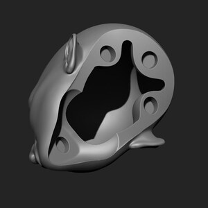 May include: A gray, abstract sculpture with a rounded shape and multiple circular and curved cutouts. The sculpture has a smooth, matte finish and is set against a dark gray background.