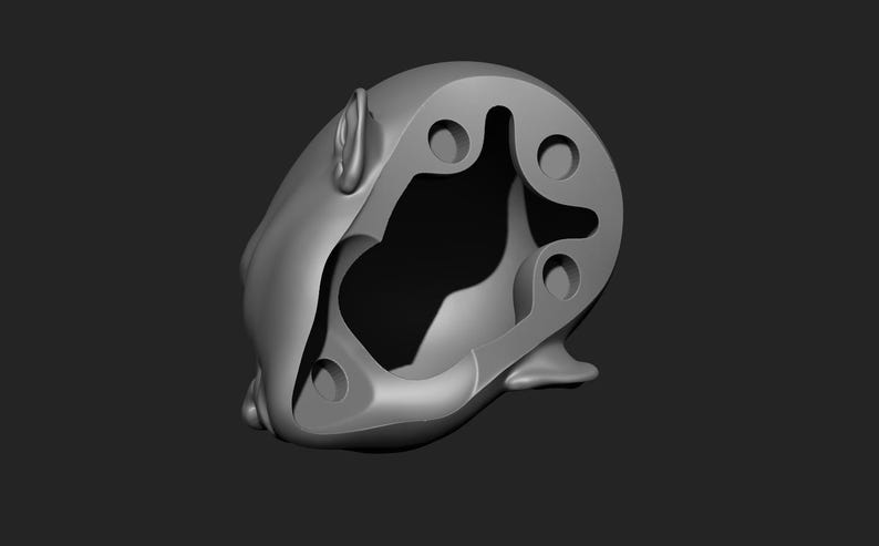 May include: A gray, abstract sculpture with a rounded shape and multiple circular and curved cutouts. The sculpture has a smooth, matte finish and is set against a dark gray background.