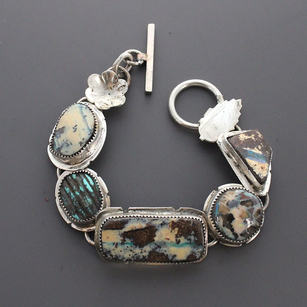 Four Opals with a Carved Turquoise