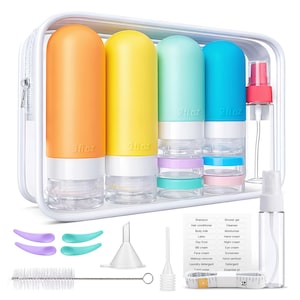 May include: A clear travel kit with colorful bottles and jars. The kit includes orange, yellow, teal, and blue bottles, each labeled with their fluid ounce capacity. Also included are small jars, spray bottles, funnels, scoops, a brush, and a measuring tape.