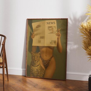 May include: A framed print featuring a woman holding a newspaper with the headline "NEWS". The woman is wearing leopard print underwear and is accompanied by a leopard. The print has a vintage aesthetic.