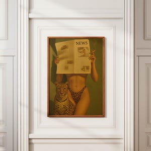 May include: A framed art print featuring a woman holding a newspaper with the headline "NEWS" and a cigarette. A leopard sits beside the woman. The woman is wearing leopard print underwear. The artwork is displayed on a white wall.