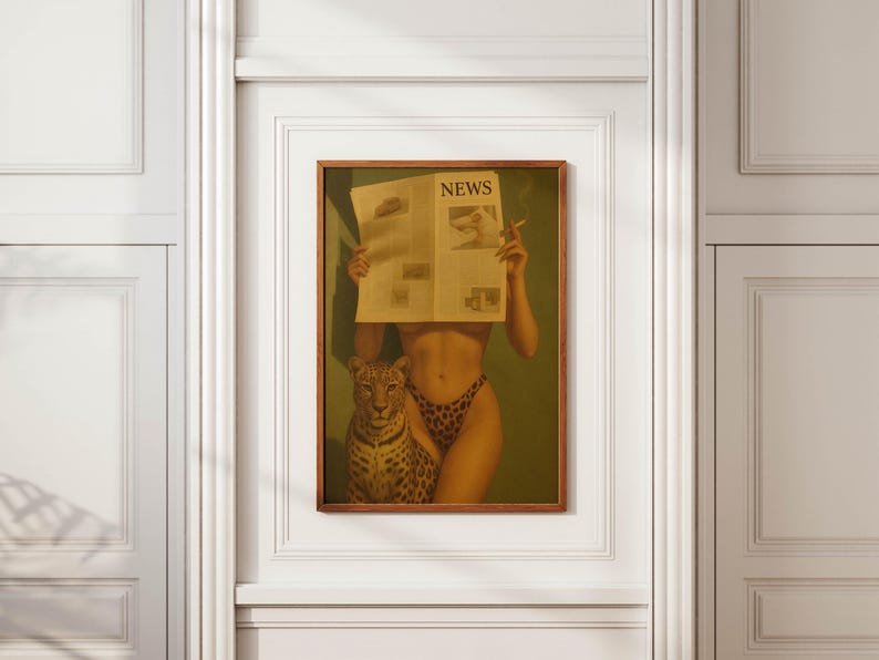May include: A framed art print featuring a woman holding a newspaper with the headline "NEWS" and a cigarette. A leopard sits beside the woman. The woman is wearing leopard print underwear. The artwork is displayed on a white wall.