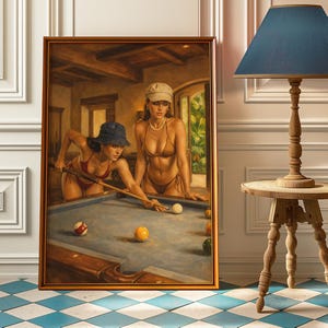 May include: A framed painting showing two people in bikinis playing pool. One is aiming with a cue, the other stands by. The pool table is blue, with coloured balls. The artwork is set in a room with a window and a wooden frame.