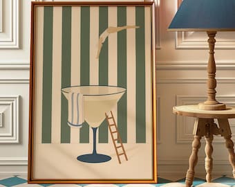 May include: Framed art print featuring a large martini glass with a ladder and a person diving in. The background has green and white vertical stripes. The frame is brown.