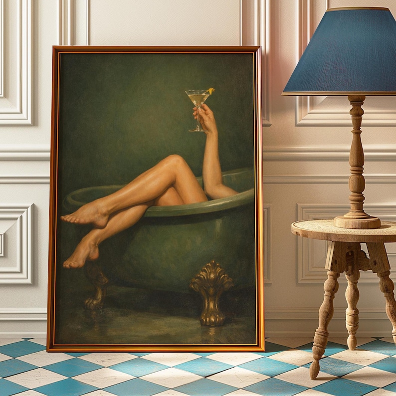 May include: A framed artwork depicts a person relaxing in a green bathtub, holding a martini. The artwork has a gold frame and is set against a green backdrop. The floor is tiled with a blue and white checkered pattern.