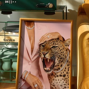 May include: Framed artwork featuring a woman in a pink suit with diamond jewelry, a roaring leopard, and a hand on the leopard's head. A green record player is in the background.