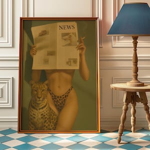 May include: A framed artwork featuring a woman holding a newspaper with the word "NEWS" visible. She is wearing leopard print underwear and is accompanied by a leopard. The artwork is in a gold frame.