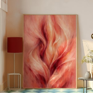 May include: Large framed abstract painting with a wooden frame. The artwork features flowing brushstrokes in shades of red, pink, and cream. The painting is displayed in a room with a red lamp and a patterned floor.