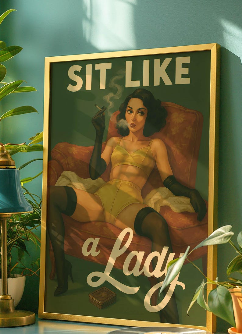 May include: Framed art print with a vintage illustration. The artwork features a woman in yellow lingerie, black gloves, and stockings, smoking a cigarette while seated in a red armchair. The text "SIT LIKE a Lady" is displayed in white.