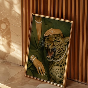 May include: Framed artwork featuring a woman in a green suit and a roaring leopard adorned with diamond jewelry. The artwork is set against a backdrop of a wooden wall and tiled floor, creating a luxurious aesthetic.