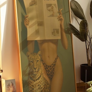 May include: Framed art print featuring a woman holding a newspaper with the headline "NEWS". A leopard stands beside her. The woman wears leopard print bottoms and holds a lit cigarette. The artwork has a gold frame.