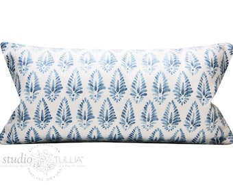 May include: A white lumbar pillow with a blue and white paisley pattern. The pillow is handmade in the USA by Studio Tullia.
