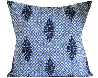 Op de afbeelding: Blauw en wit gepatroneerd kussen met een geometrisch ontwerp. Het kussen is vierkant en heeft een zacht, comfortabel gevoel.