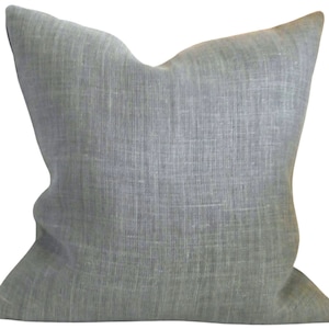 May include: A soft, grey linen pillow with a subtle textured weave. The pillow is square and has a simple, understated design.