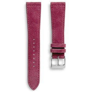 May include: Two-piece watch strap in a deep magenta color. The straps are made of a suede-like material and feature stitching along the edges. One strap has a silver-colored buckle. The straps are designed to attach to a watch face.