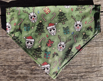 May include: Green bandana with a Christmas theme featuring a repeating pattern of hockey masks, candy canes, Christmas trees, and reindeer. The masks are red and white with black details. The candy canes are red and white. The Christmas trees are green with red and white ornaments. The reindeer are brown with red noses.