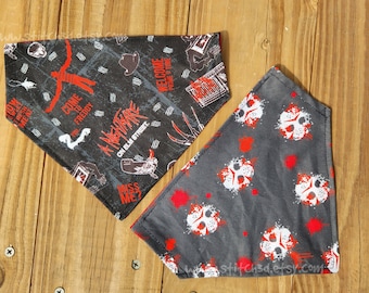 May include: Two black and gray dog bandanas with horror movie themes. One bandana features a white and red Freddy Krueger design with the text "A Nightmare on Elm Street" and "Come to Freddy". The other bandana features a white and red Jason Voorhees design with blood splatters.