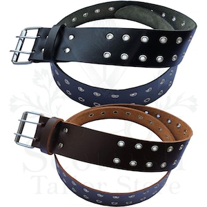 May include: Three leather belts in black, navy blue, and brown. Each belt features double rows of silver grommets and a silver buckle. The belts are designed for casual wear and are suitable for various outfits.