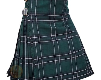 May include: A green and black tartan kilt with white lines. The kilt has pleats and fringe along the edge. Two leather straps with silver buckles secure the kilt at the waist. The kilt is made of a woven fabric.