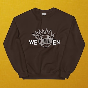 May include: A brown sweatshirt with a white graphic of a cartoon face with a crown of spikes and the text "WEEN" underneath.